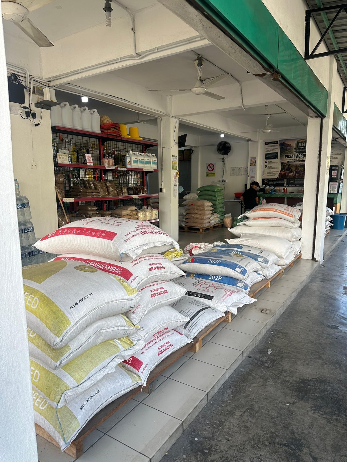 Guni makanan ternakan tersusun di ruang hadapan kedai